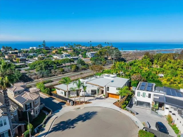 an aerial view of a house with garden space and street view