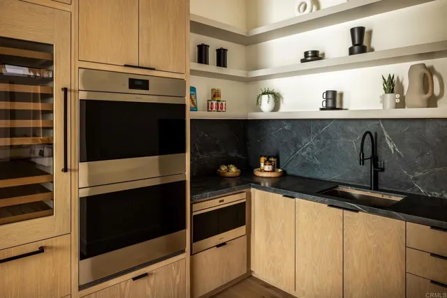 a kitchen with stainless steel appliances a stove and cabinets