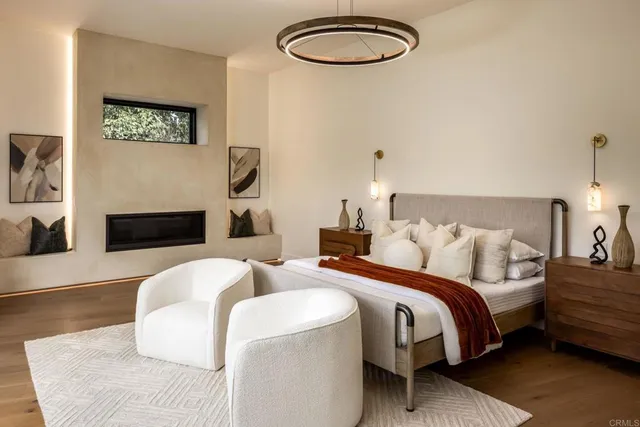 a bedroom with bed and a chandelier