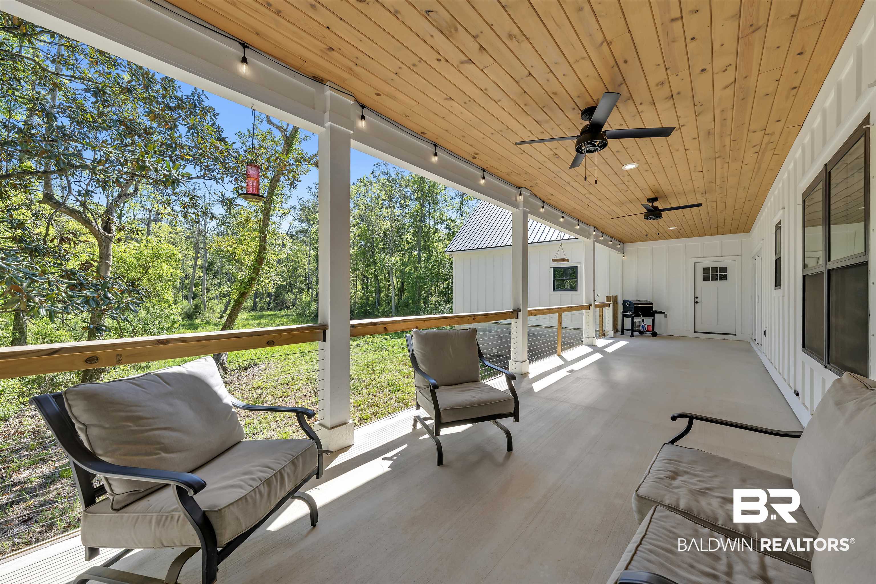 19058 James Road Gulf Shores, AL 36542 - Photo 39 of 49 Sunroom / solarium with rail lighting, ceiling fan, and a patio