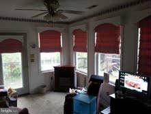 19252 Fort Valley Road Strasburg, VA 22657 - Photo 3 of 11 a living room with furniture windows and a fireplace