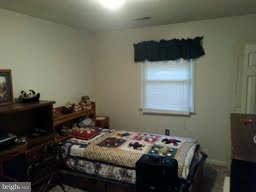19252 Fort Valley Road Strasburg, VA 22657 - Photo 10 of 11 a bedroom with a bed and a window