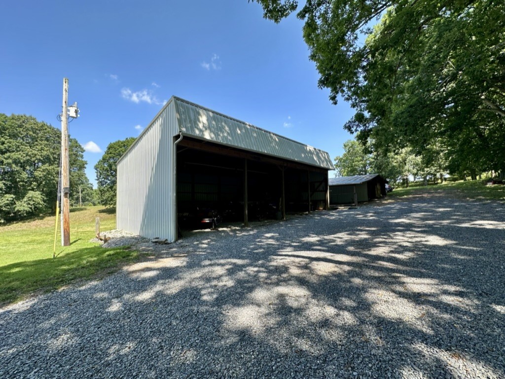 188 Link Road Cottontown, TN 37048 - Photo 33 of 45 a view of a house with a yard and garage