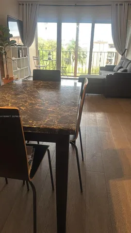 a view of a workspace with furniture and window