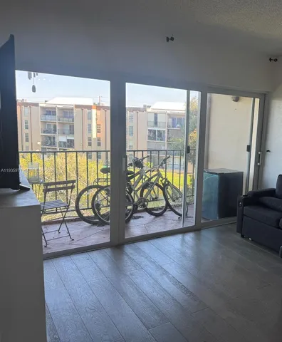 a view of a work space with furniture and wooden floor