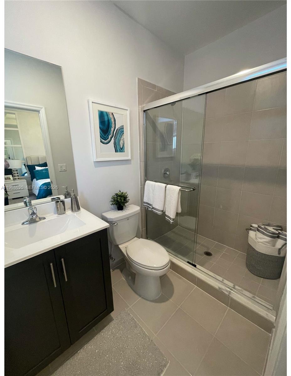 1879 Southeast 27th Street Homestead, FL 33035 - Photo 9 of 10 a bathroom with a sink mirror vanity and toilet