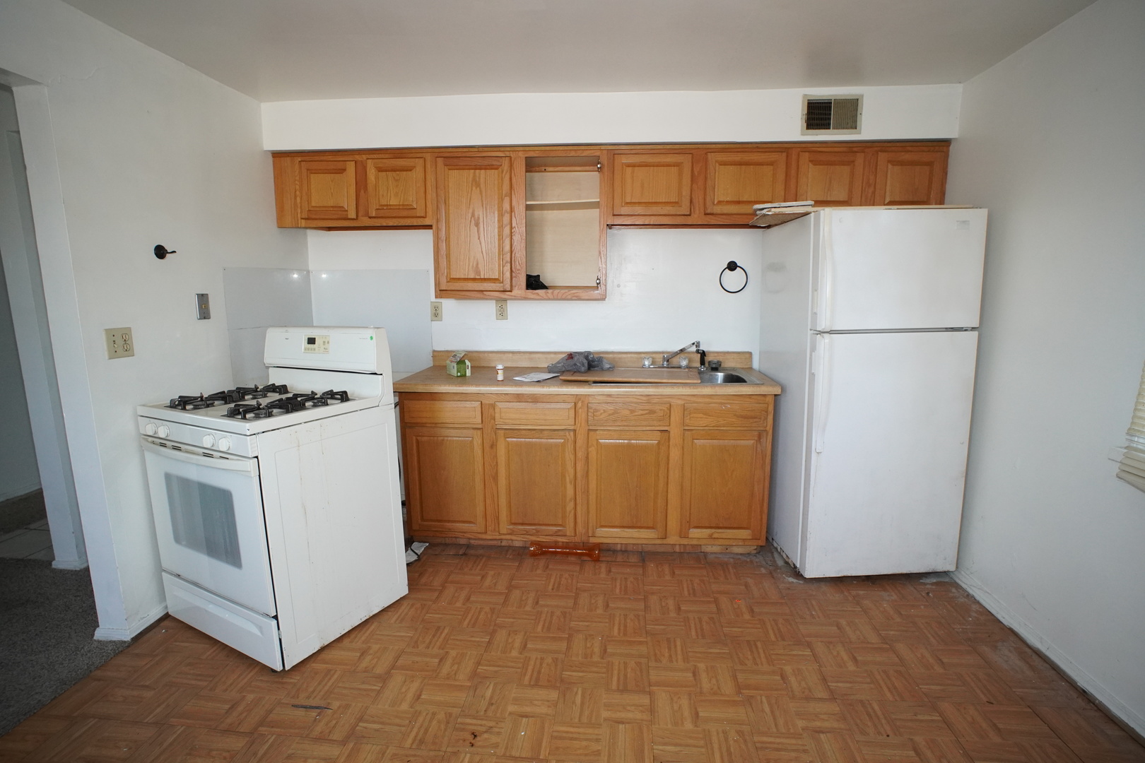 5425 Melton Road Gary, IN 46403 - Photo 6 of 31 a kitchen with a stove a sink and a refrigerator