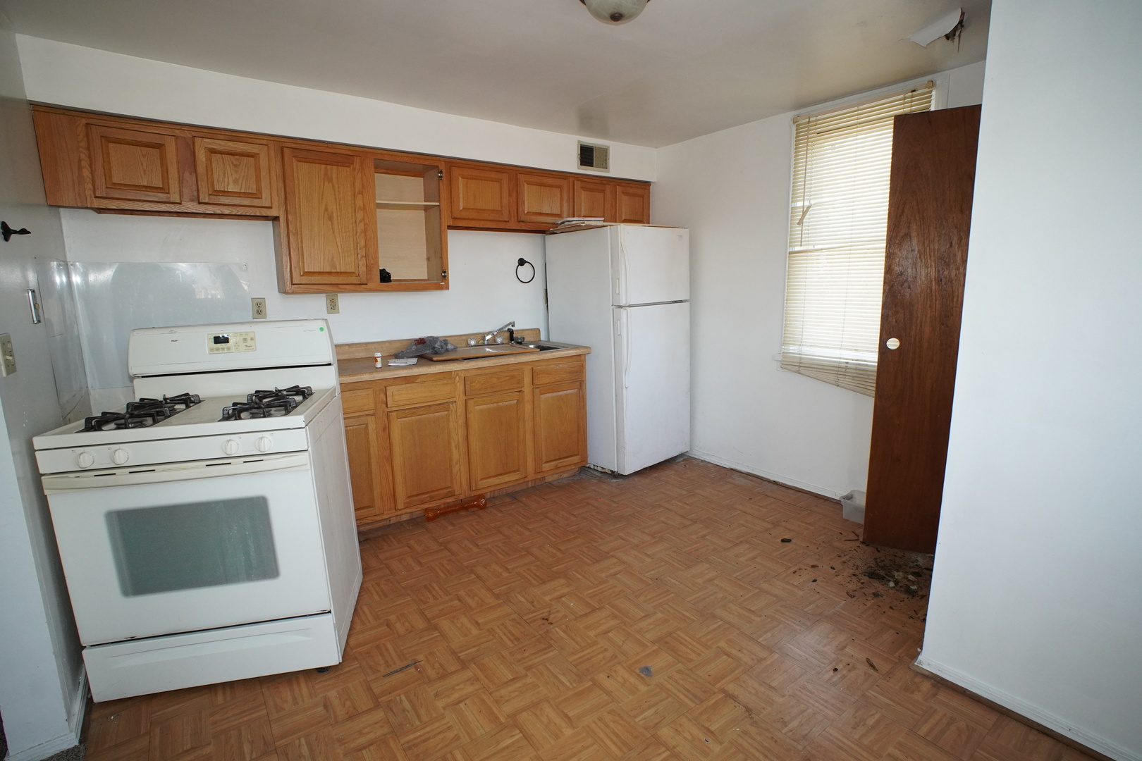 5425 Melton Road Gary, IN 46403 - Photo 7 of 31 a kitchen with a stove sink and a refrigerator