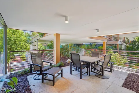a view of an outdoor dining space with furniture and garden