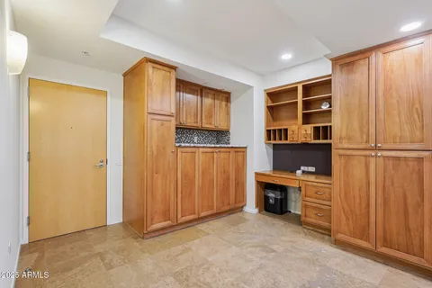 a view of an empty room with a cabinet and a window