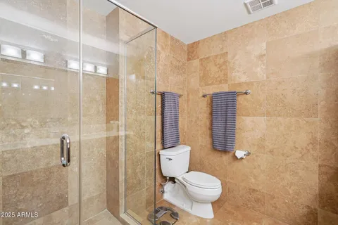 a bathroom with a toilet and shower