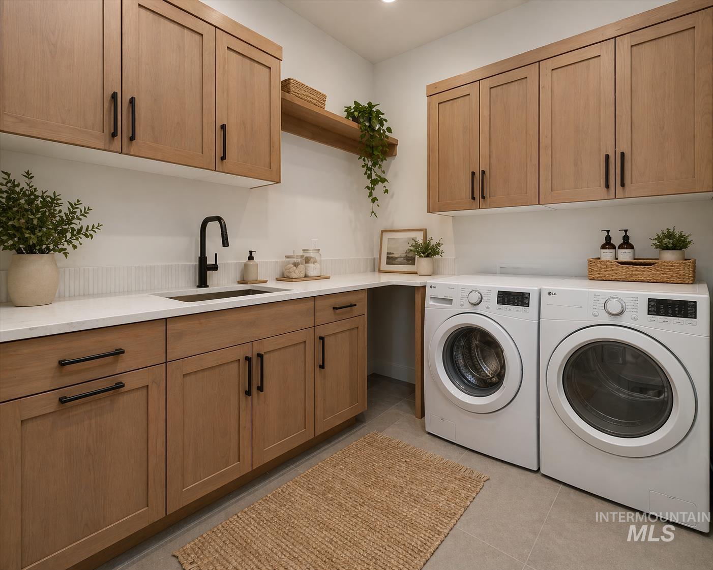 539 Century Avenue Middleton, ID 83644 - Photo 41 of 50 Laundry area with cabinet space, light tile patterned floors, and washing machine and dryer