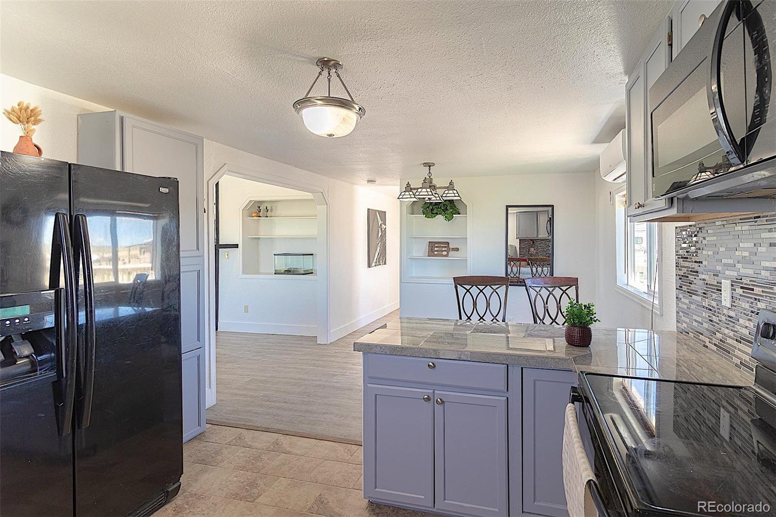 3415 Wiesner Road Calhan, CO 80808 - Photo 12 of 33 a kitchen with stainless steel appliances granite countertop a refrigerator and microwave