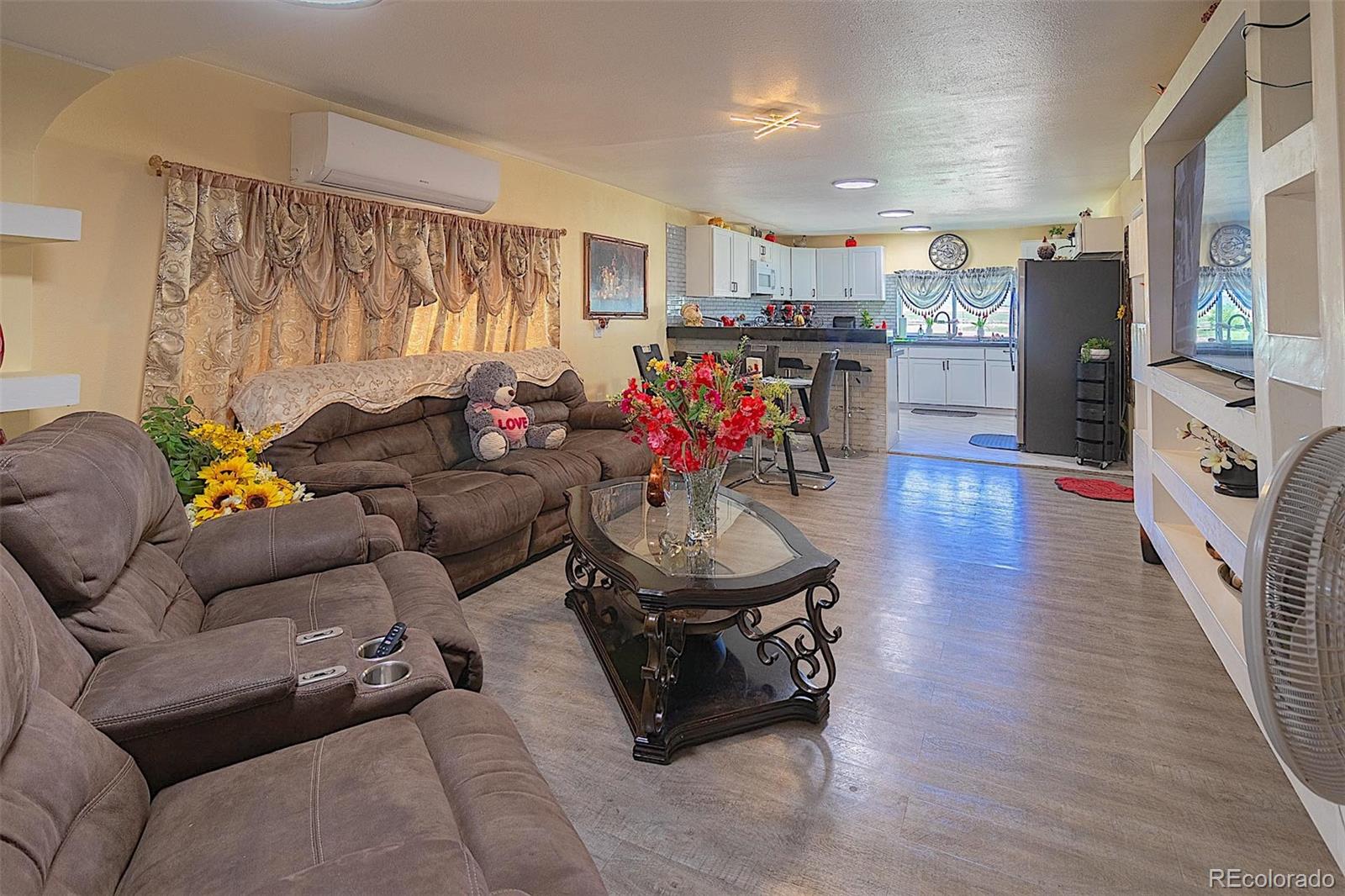 3415 Wiesner Road Calhan, CO 80808 - Photo 20 of 33 a living room with furniture and a flat screen tv