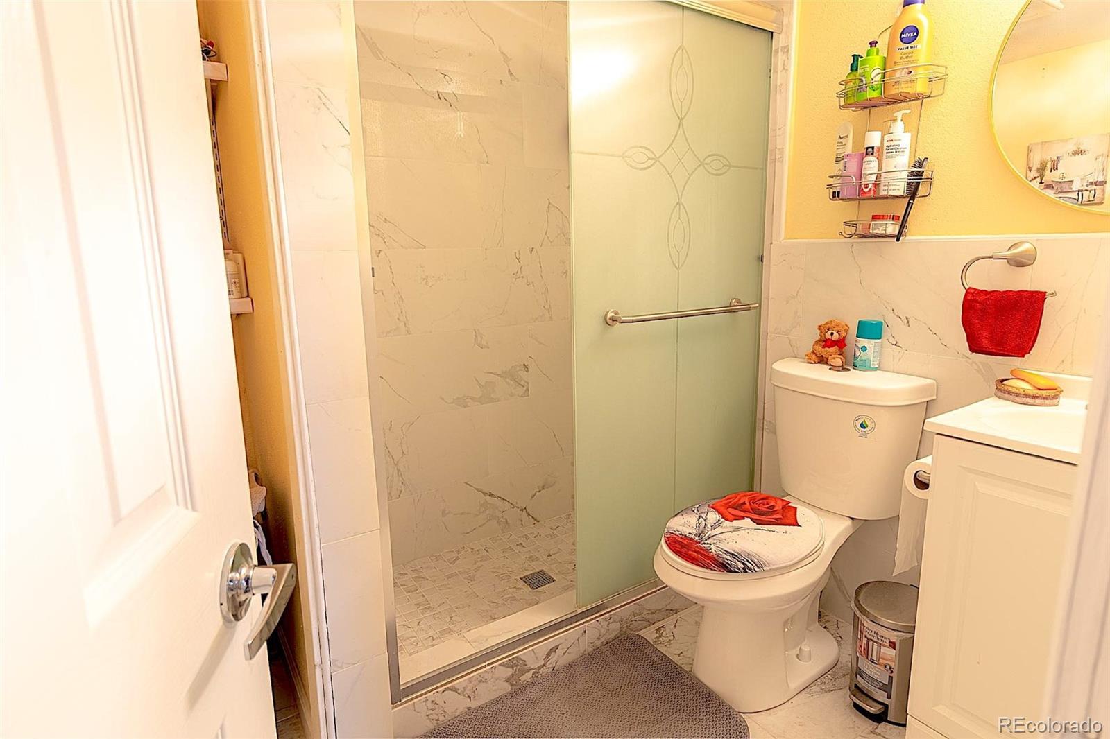 3415 Wiesner Road Calhan, CO 80808 - Photo 21 of 33 a white toilet sitting next to a bathroom sink and a shower