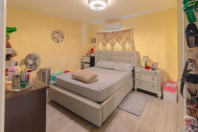 a open kitchen with stainless steel appliances granite countertop a stove top oven a sink dishwasher and a microwave with wooden floor