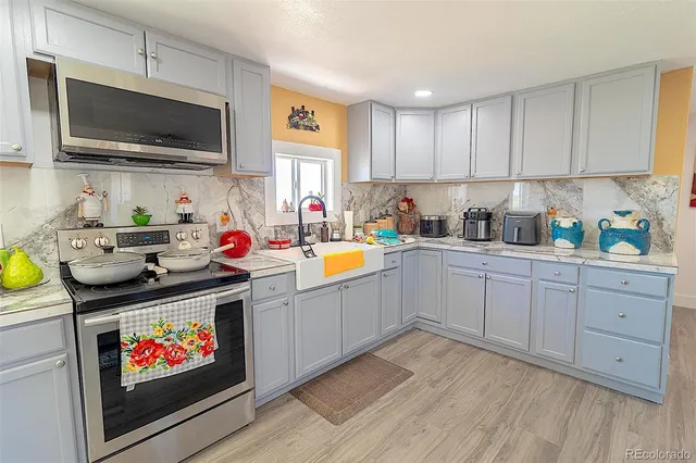 a kitchen with a refrigerator and a stove