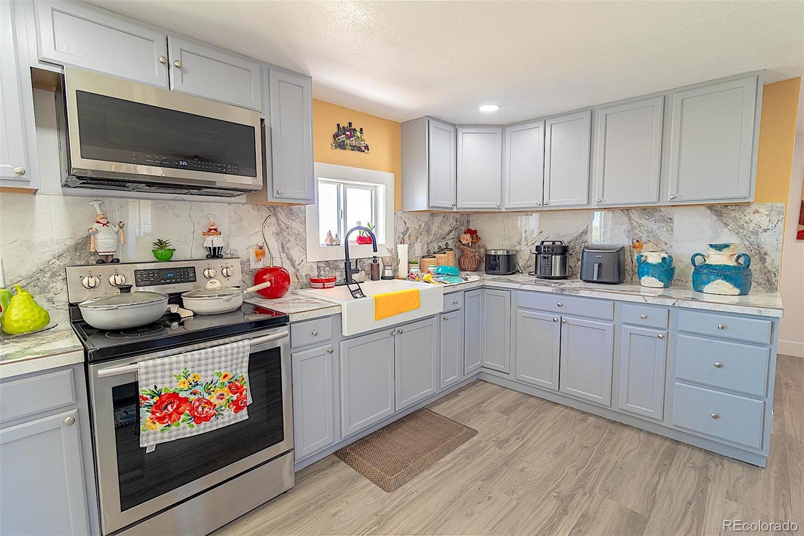 3415 Wiesner Road Calhan, CO 80808 - Photo 24 of 33 a kitchen with microwave a stove and cabinets