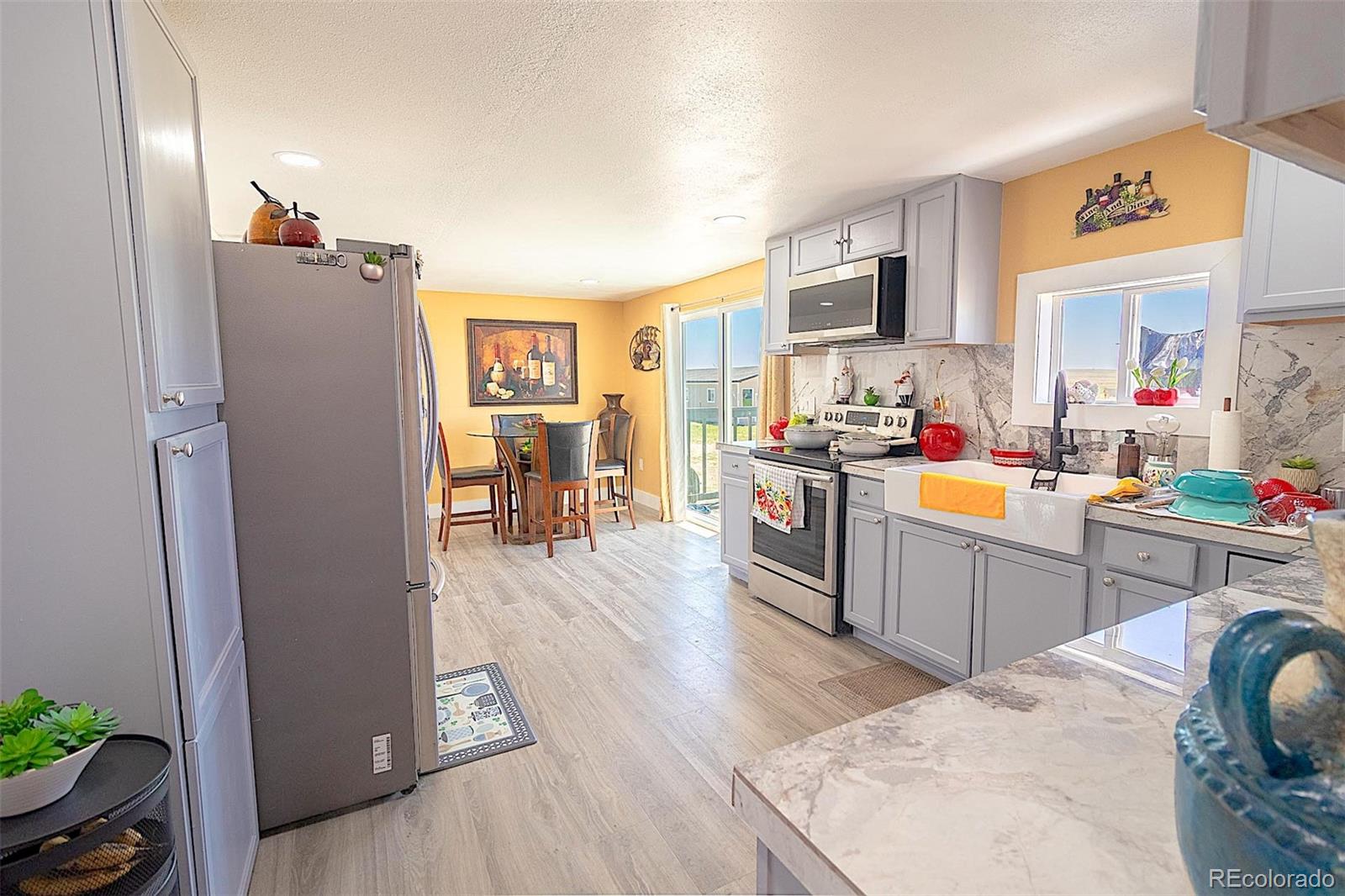 3415 Wiesner Road Calhan, CO 80808 - Photo 25 of 33 a kitchen with a refrigerator and a stove