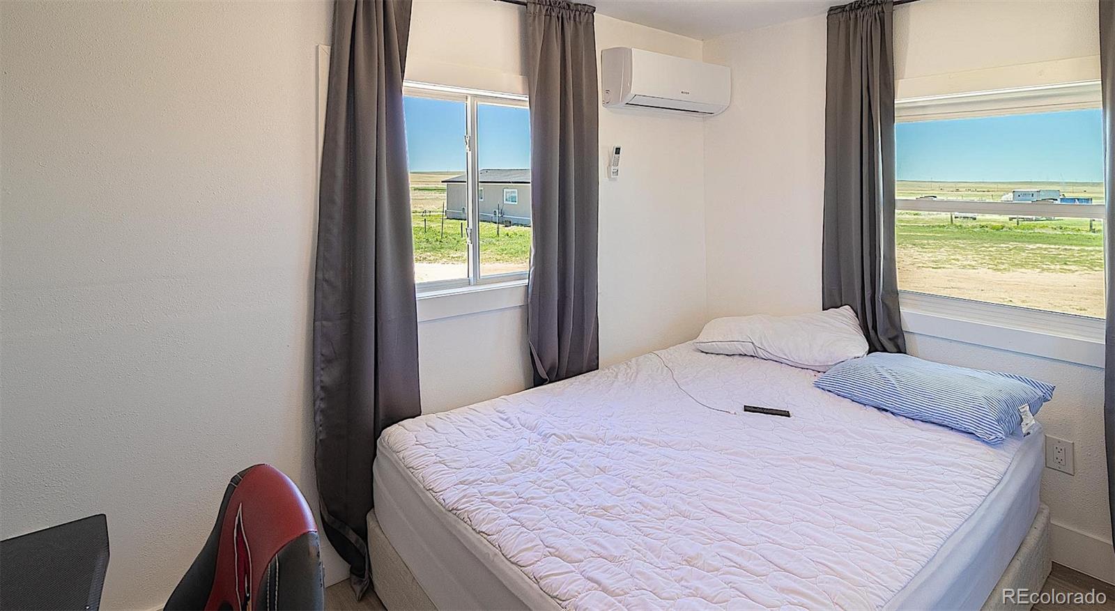 3415 Wiesner Road Calhan, CO 80808 - Photo 29 of 33 a bedroom with a bed and a window