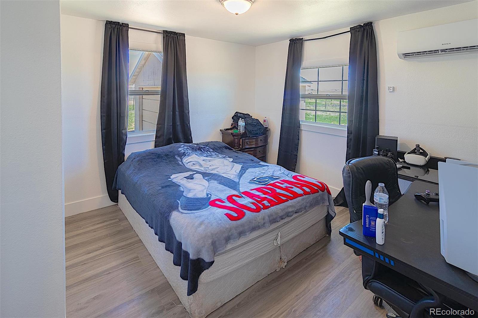 3415 Wiesner Road Calhan, CO 80808 - Photo 30 of 33 a bedroom with a bed and wooden floor