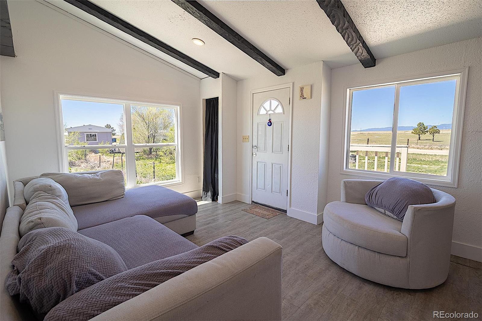 3415 Wiesner Road Calhan, CO 80808 - Photo 9 of 33 a living room with furniture and a large window