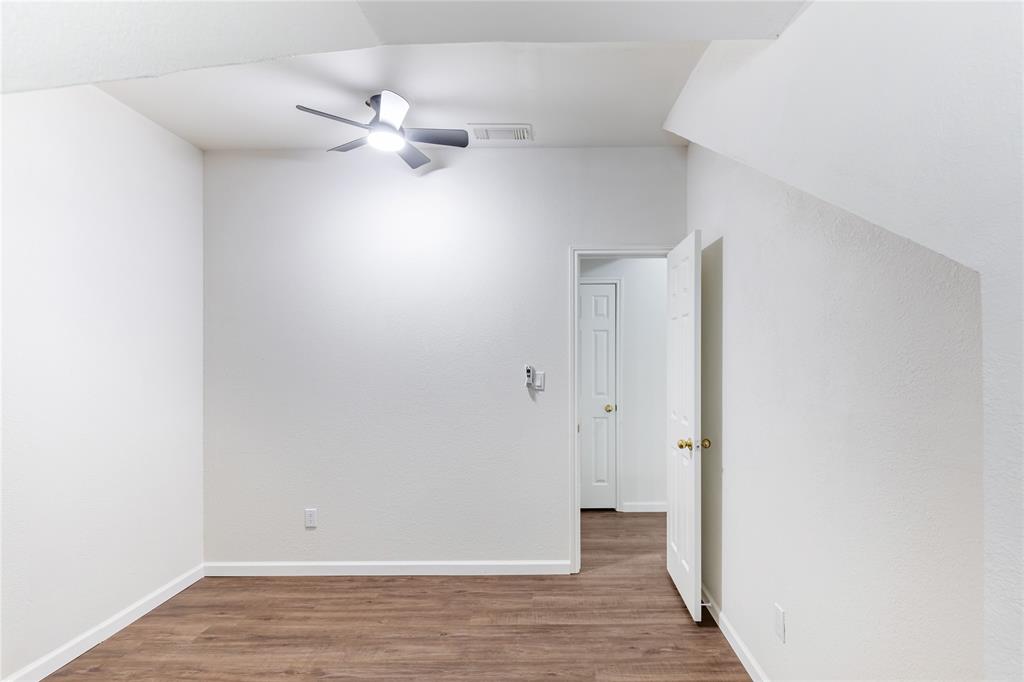 12680 Hillcrest Road, Unit 4101 Dallas, TX 75230 - Photo 14 of 37 Room featuring wood-finish flooring, crisp white walls, and a contemporary ceiling fan with integrated lighting