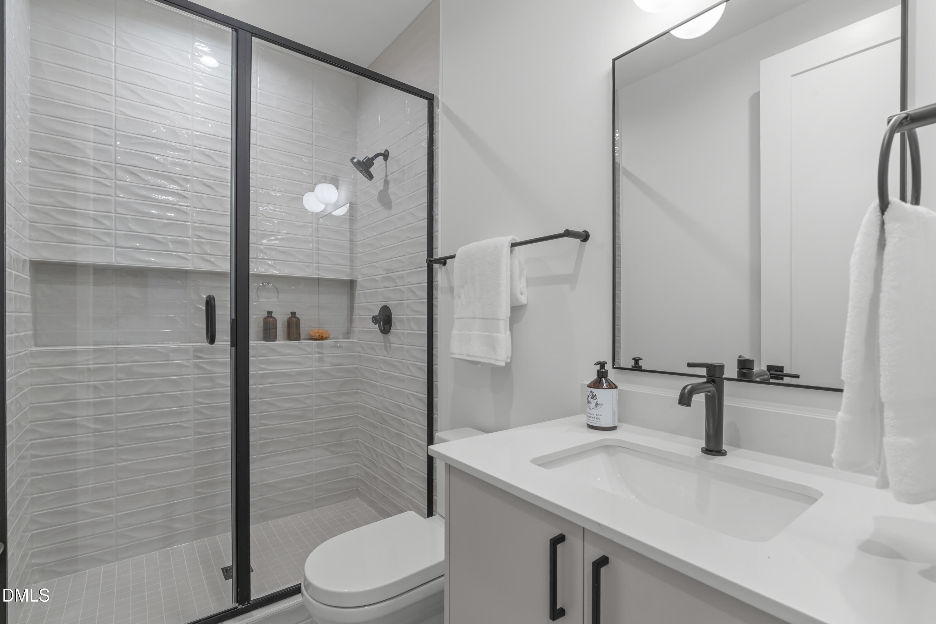 1307 Chamblee Hl Court Raleigh, NC 27608 - Photo 40 of 65 a bathroom with a sink a toilet and shower