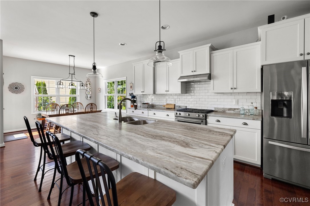 11200 Avening Road Midlothian, VA 23112 - Photo 11 of 35 a kitchen with stainless steel appliances granite countertop a stove a refrigerator a kitchen island a table and chairs