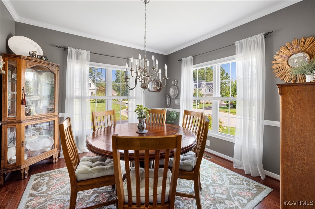11200 Avening Road Midlothian, VA 23112 - Photo 6 of 35 a dining room with furniture a chandelier and wooden floor