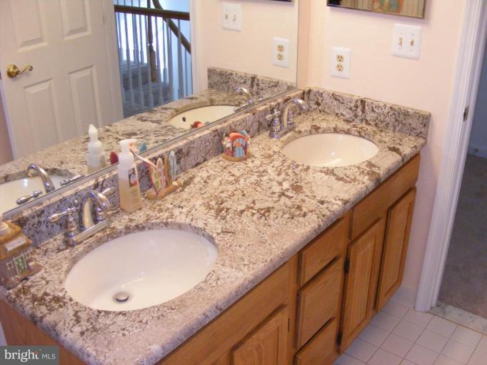 1219 Providence Road Towson, MD 21286 - Photo 16 of 27 a bathroom with a granite countertop sink and a mirror
