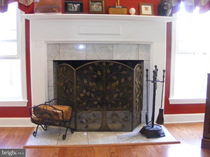 1219 Providence Road Towson, MD 21286 - Photo 4 of 27 a living room with a fireplace and a rug
