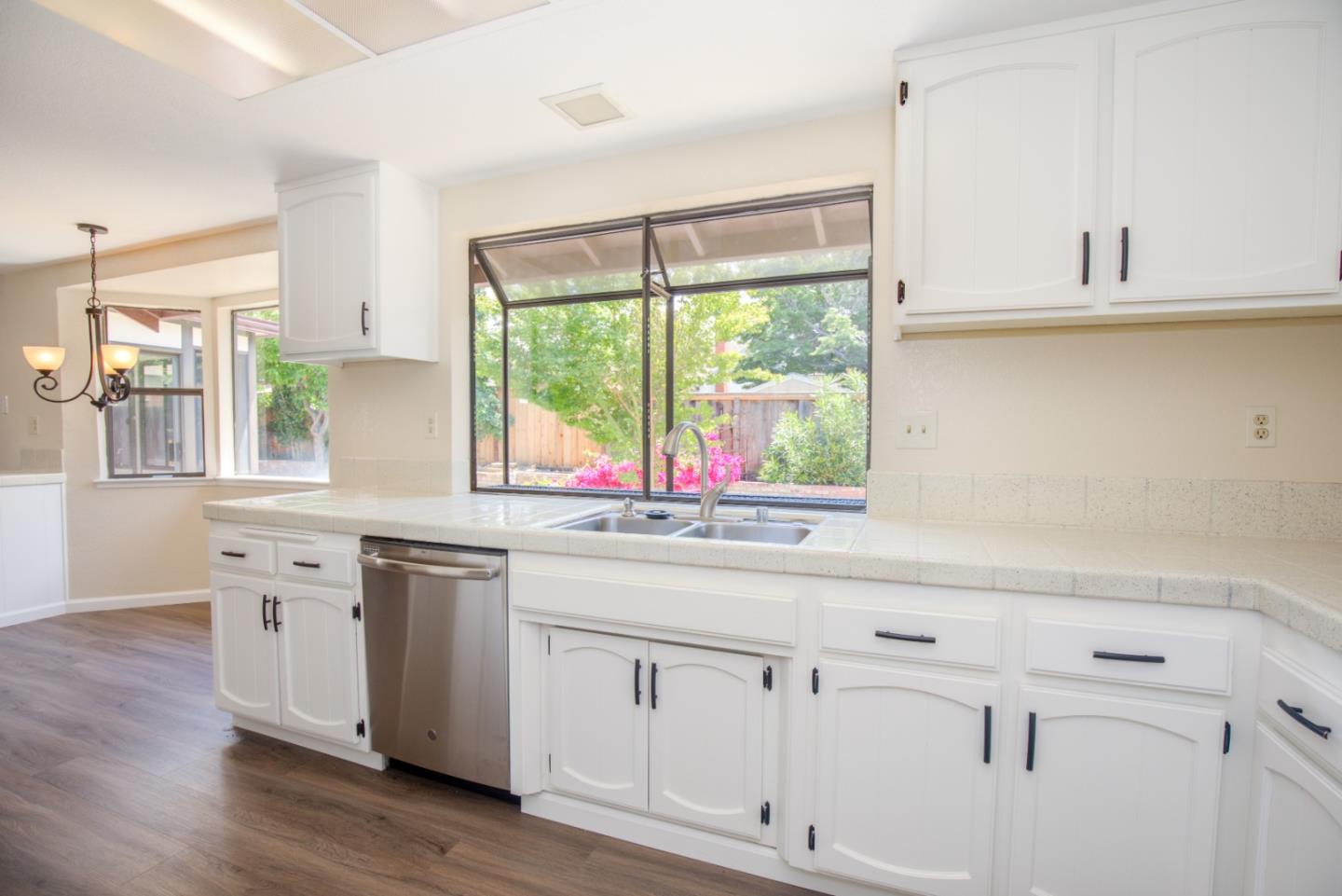 2774 Boncheff Drive San Jose, CA 95133 - Photo 13 of 38 a kitchen with white cabinets and a window
