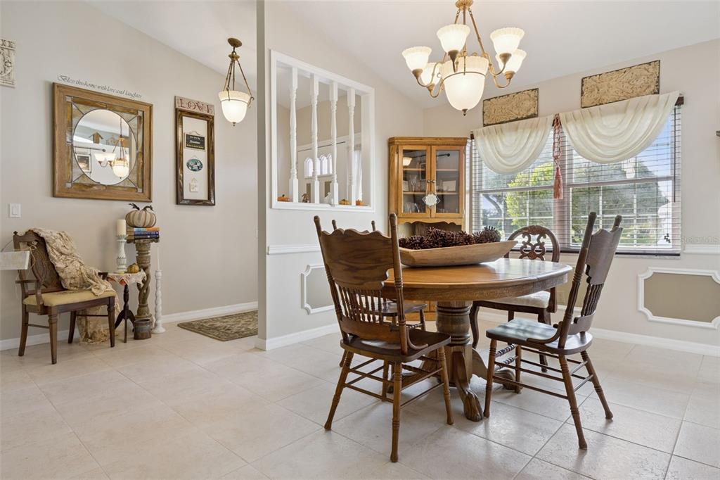 26600 Racquet Circle Leesburg, FL 34748 - Photo 12 of 80 a dining room with furniture a chandelier and a rug