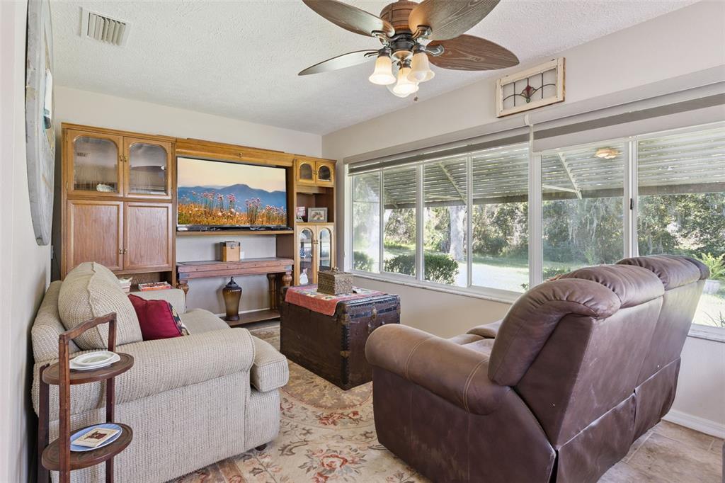 26600 Racquet Circle Leesburg, FL 34748 - Photo 20 of 80 a living room with furniture and a large window