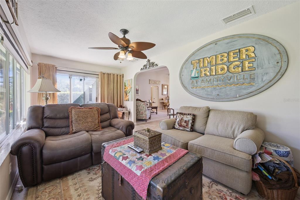 26600 Racquet Circle Leesburg, FL 34748 - Photo 21 of 80 a living room with furniture a rug and a window