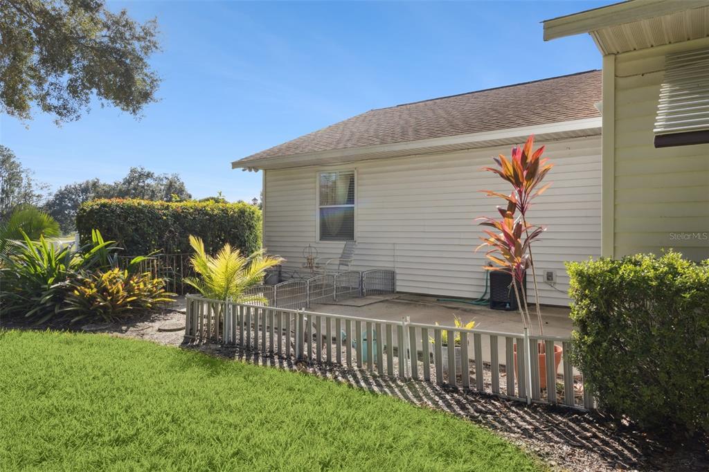 26600 Racquet Circle Leesburg, FL 34748 - Photo 35 of 80 a view of a house with a small yard and a garden
