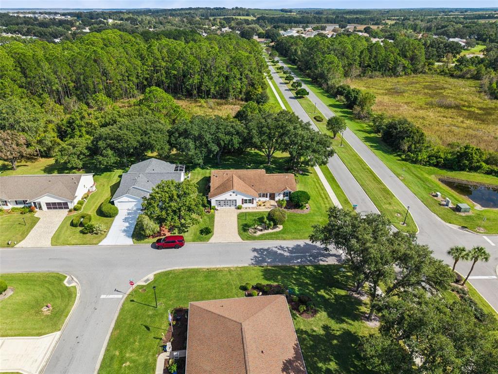 26600 Racquet Circle Leesburg, FL 34748 - Photo 36 of 80 an aerial view of a house with a garden and lake view