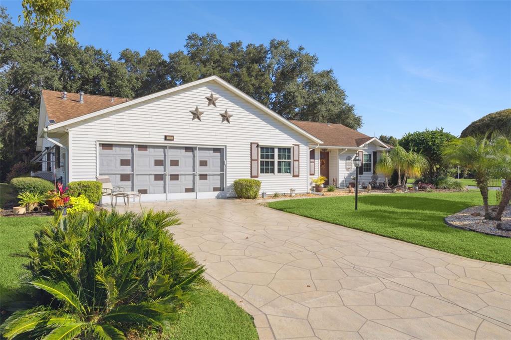 26600 Racquet Circle Leesburg, FL 34748 - Photo 4 of 80 a view of a house with yard and a garden