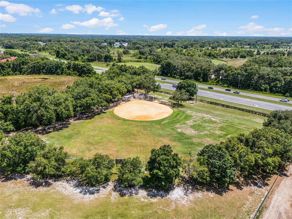 26600 Racquet Circle Leesburg, FL 34748 - Photo 68 of 80 a view of a lake with a yard
