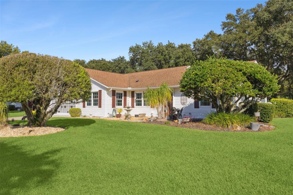 26600 Racquet Circle Leesburg, FL 34748 - Photo 7 of 80 a view of a house with backyard porch and sitting area