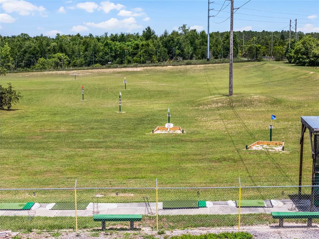 26600 Racquet Circle Leesburg, FL 34748 - Photo 72 of 80 a view of a swimming pool with a yard