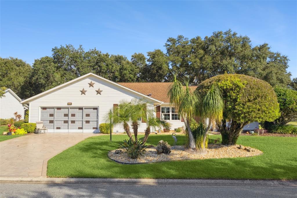 26600 Racquet Circle Leesburg, FL 34748 - Photo 8 of 80 a front view of a house with garden