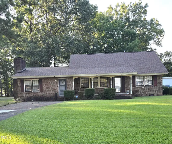 a front view of a house with a garden and porch