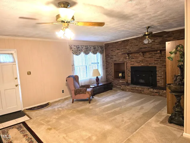 a living room with furniture and a fireplace
