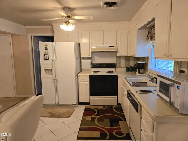 a kitchen with a stove a refrigerator and a sink