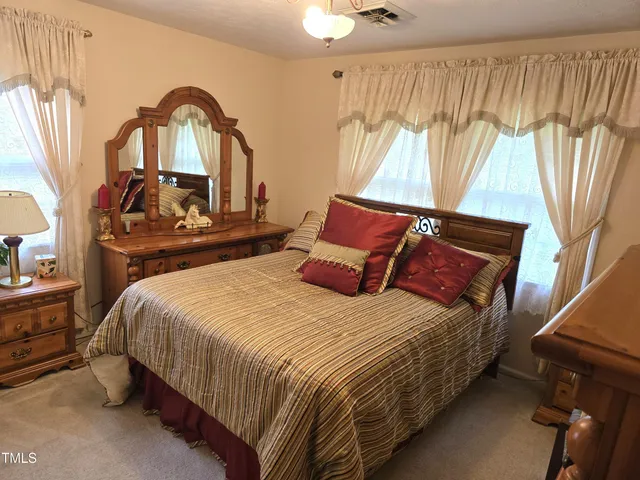 a bedroom with a bed and a mirror