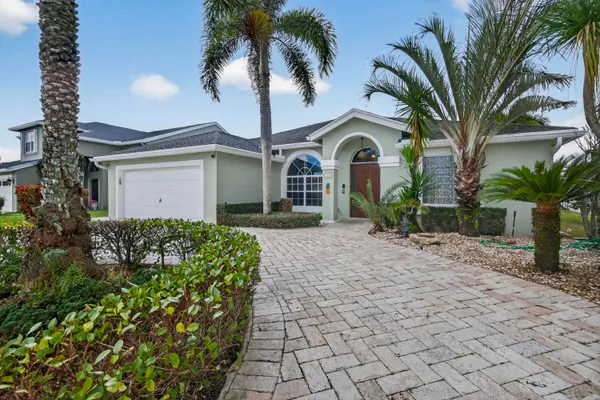 a front view of a house with a garden