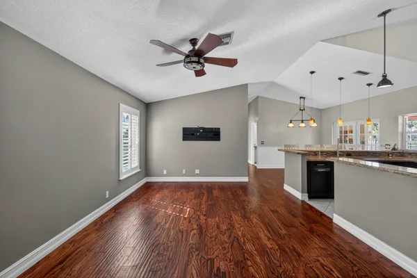 a view of a kitchen with a sink wooden floor and a window