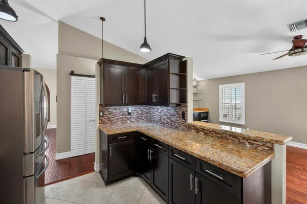 a kitchen with a stove and a refrigerator